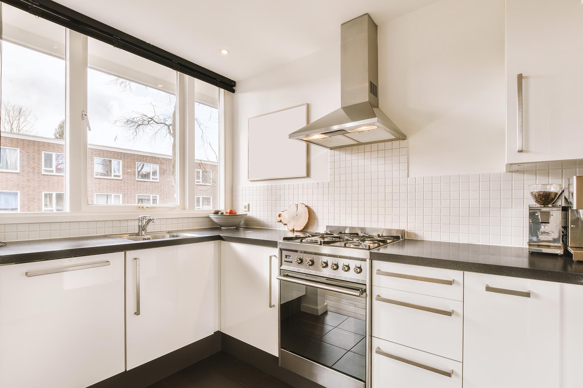 A modern kitchen featuring a stove and oven, with cabinets and countertops in a bright, inviting space.