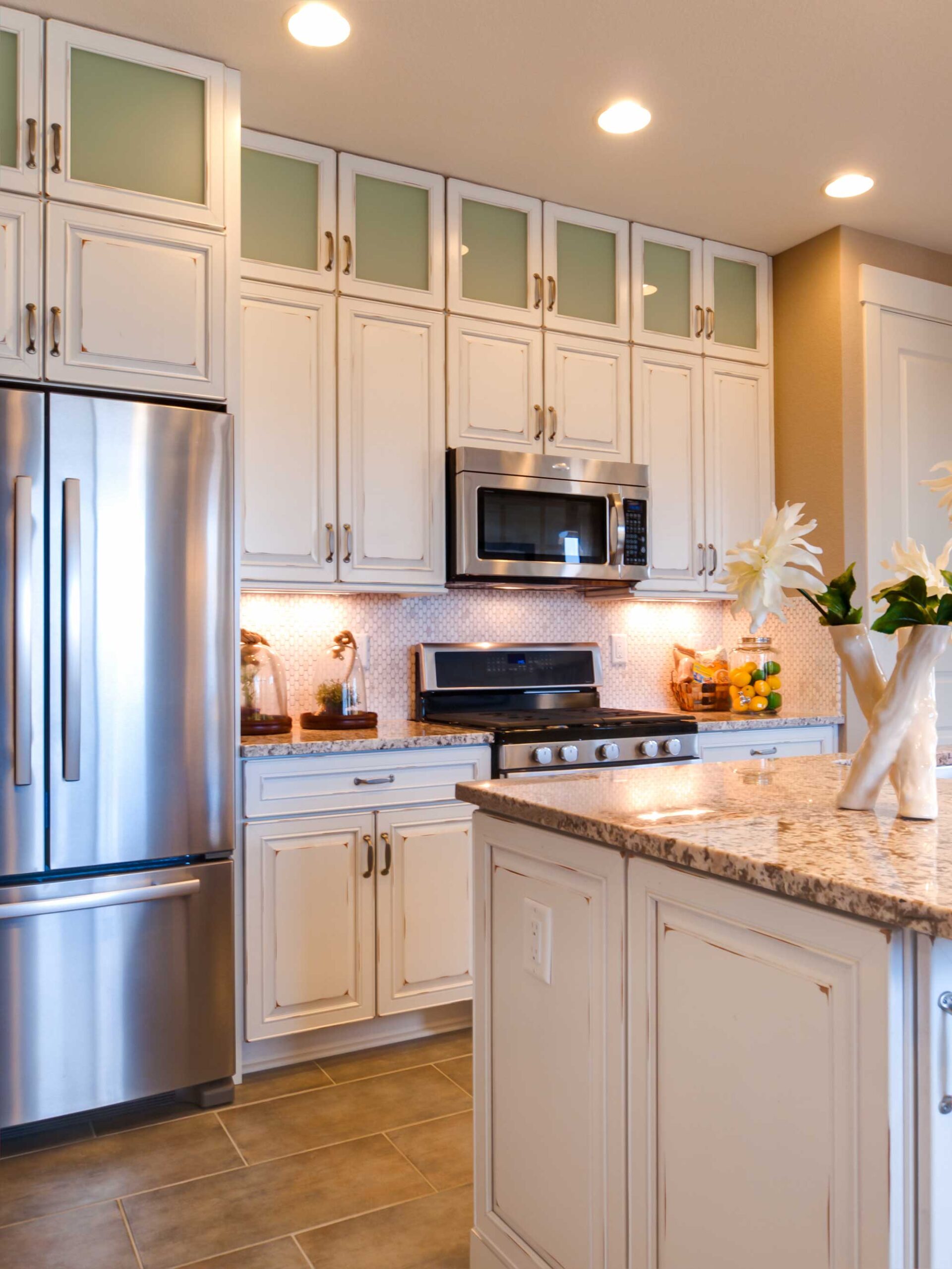 A kitchen featuring a refrigerator and a stove, showcasing a functional cooking space.